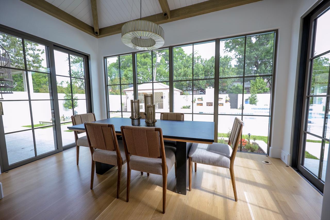 Vaulted ceiling before and after — dining room with floor-to-ceiling windows Texas remodel