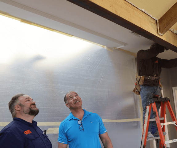 Load bearing wall removal crew looking up