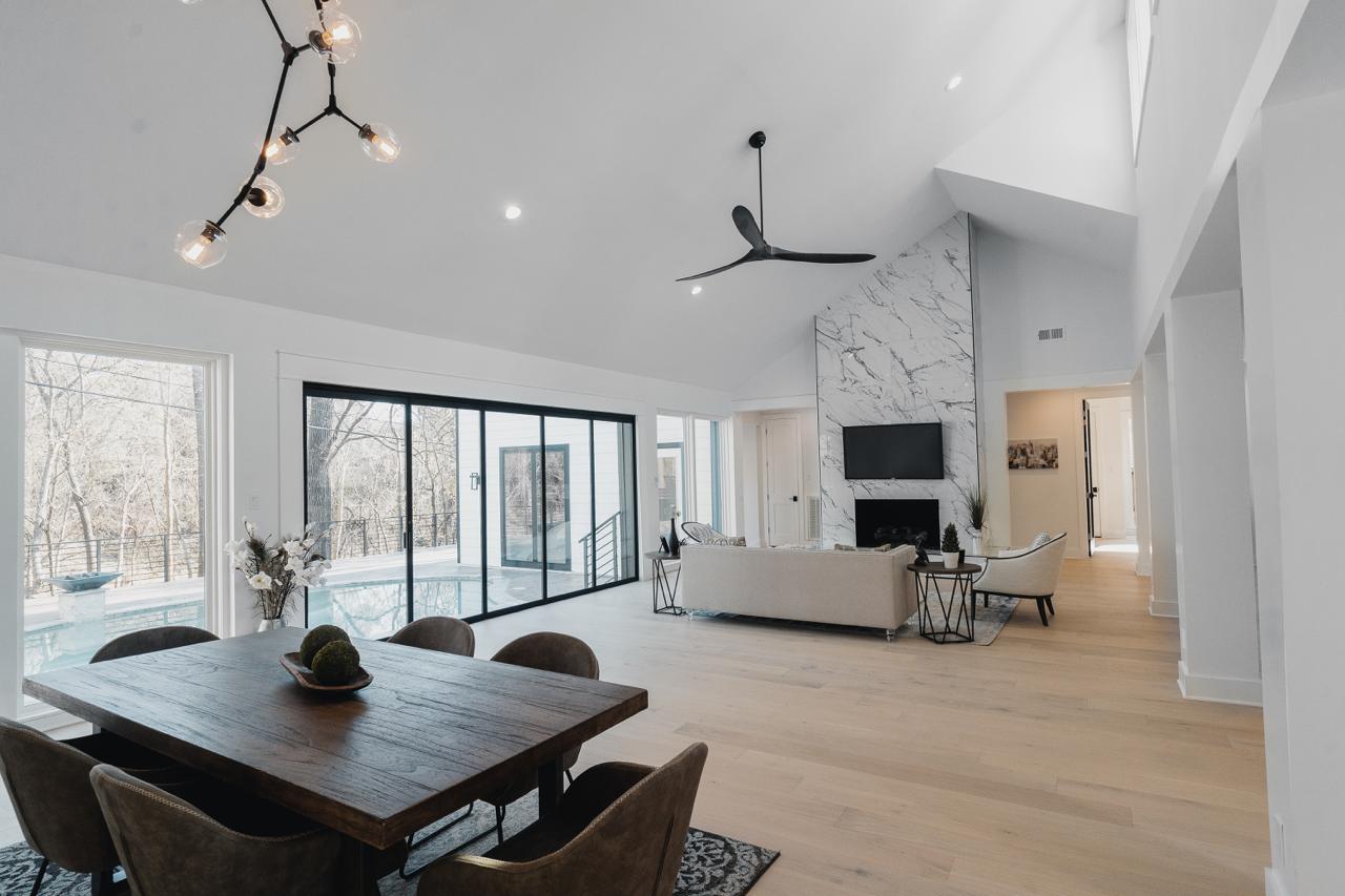 Open concept living space with marble fireplace after wall removal Texas