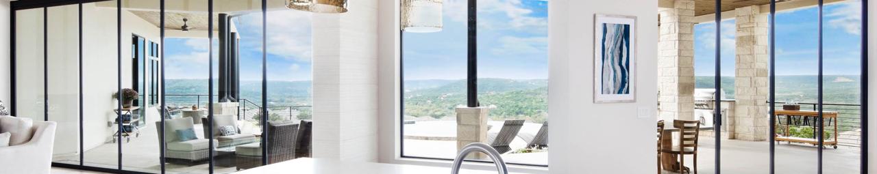 Panoramic glass door installation converting wall to outdoor living — Texas home