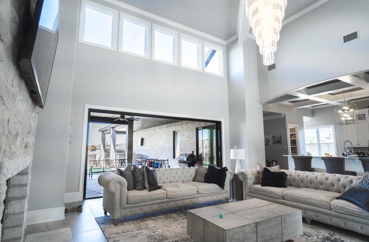 Vaulted ceiling before and after — wall to door conversion with panoramic glass doors Texas